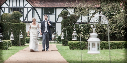 bride and groom walk towards the marquee